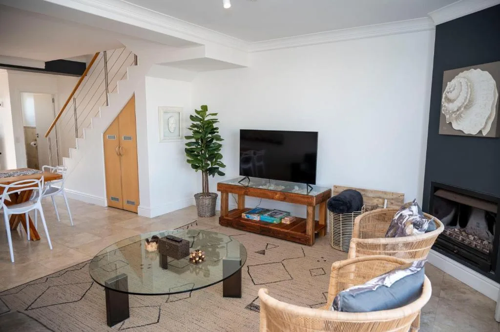 Spacious living room with TV, fireplace, and comfortable seating arrangements