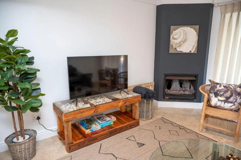 Modern living room with television, fireplace, and comfortable seating