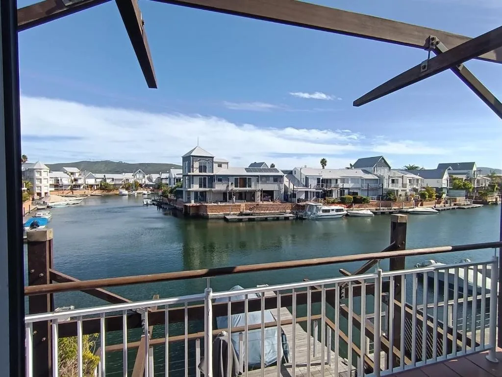 Waterfront lagoon view with moored boats and colorful houses