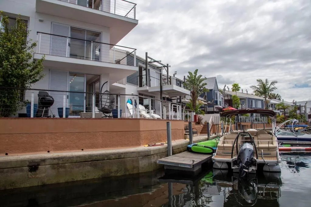 Modern waterfront home with private jetty and boat access on canal