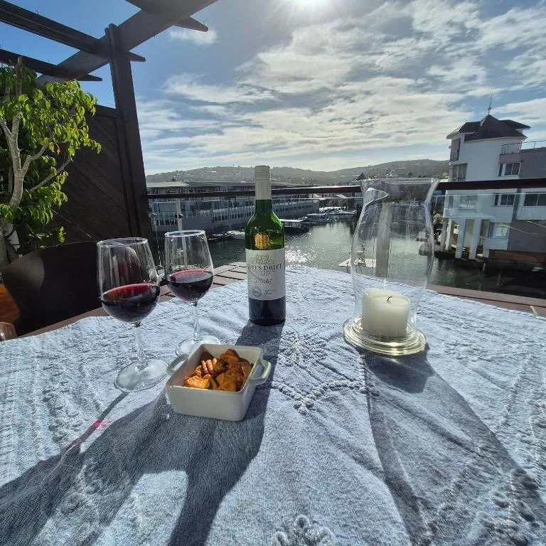 Waterfront deck with wine, snacks, and scenic lagoon views