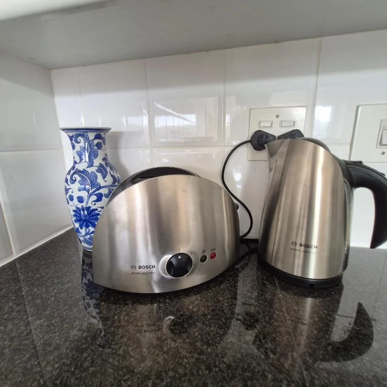 Stainless steel kitchen appliances and blue decorative vase on counter
