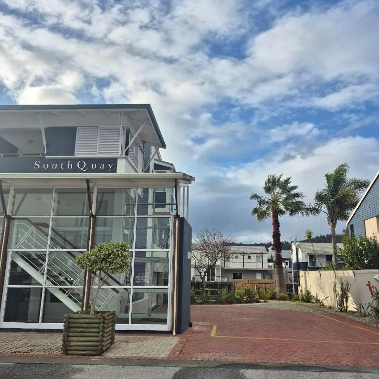 Modern SouthQuay apartment building with glass frontage and palm trees