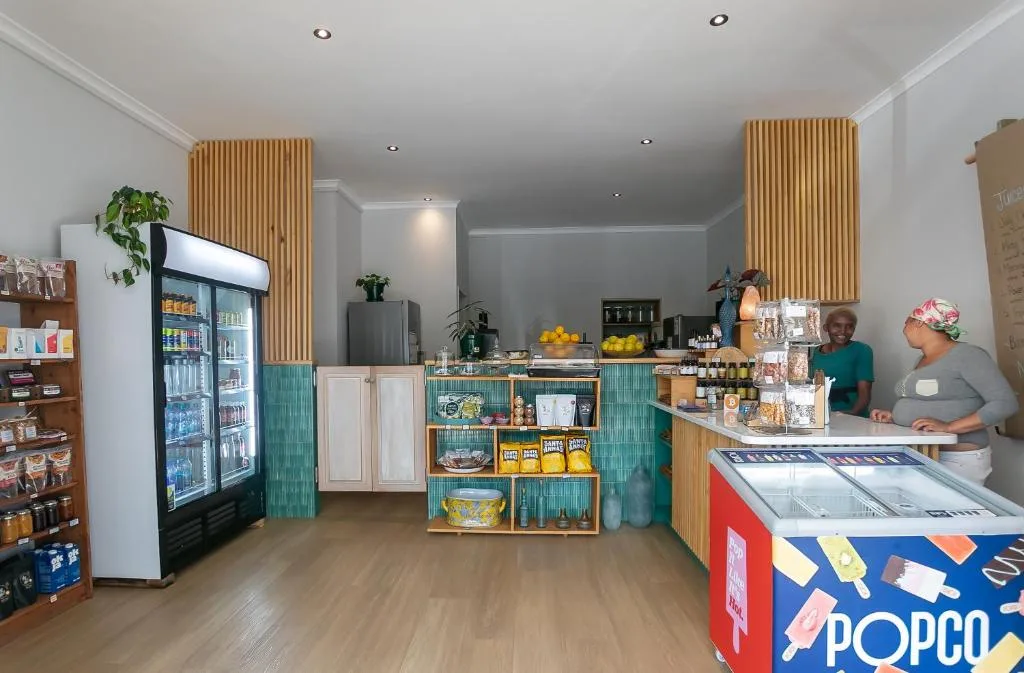 Interior shop counter with refrigerated beverages and packaged goods display