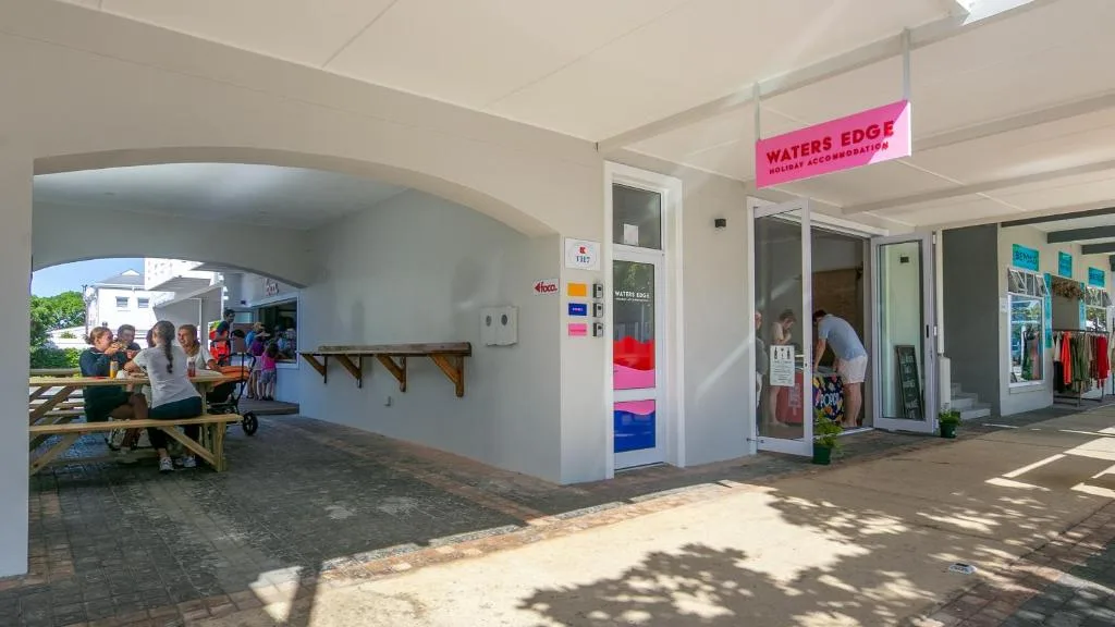 White building exterior with covered patio area and Waters Edge signage