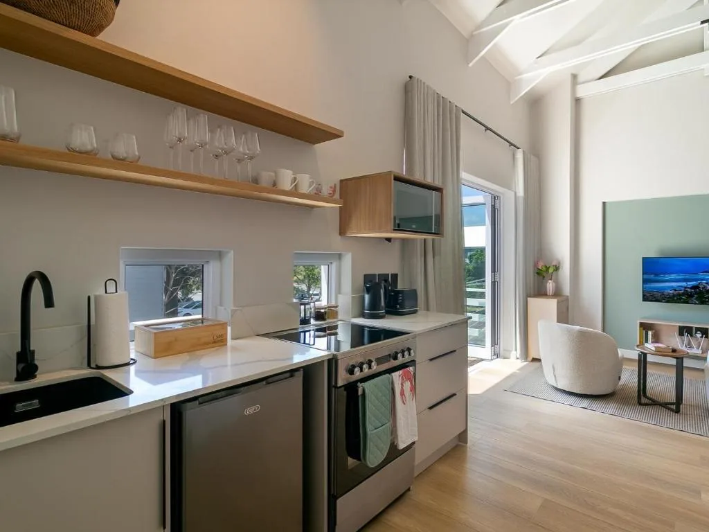 Modern kitchen with stainless steel appliances and wooden shelving