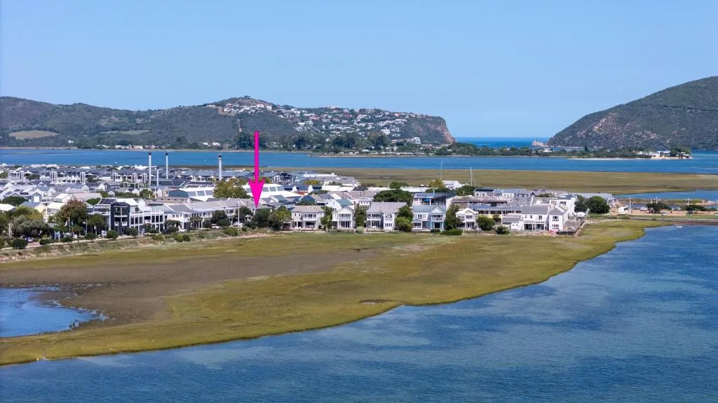 Aerial view of Knysna lagoon with property location marked by pink arrow