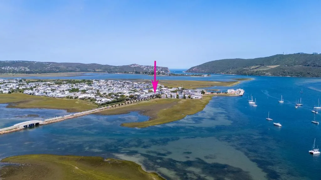 Aerial view of Knysna lagoon with anchored sailboats and coastal town