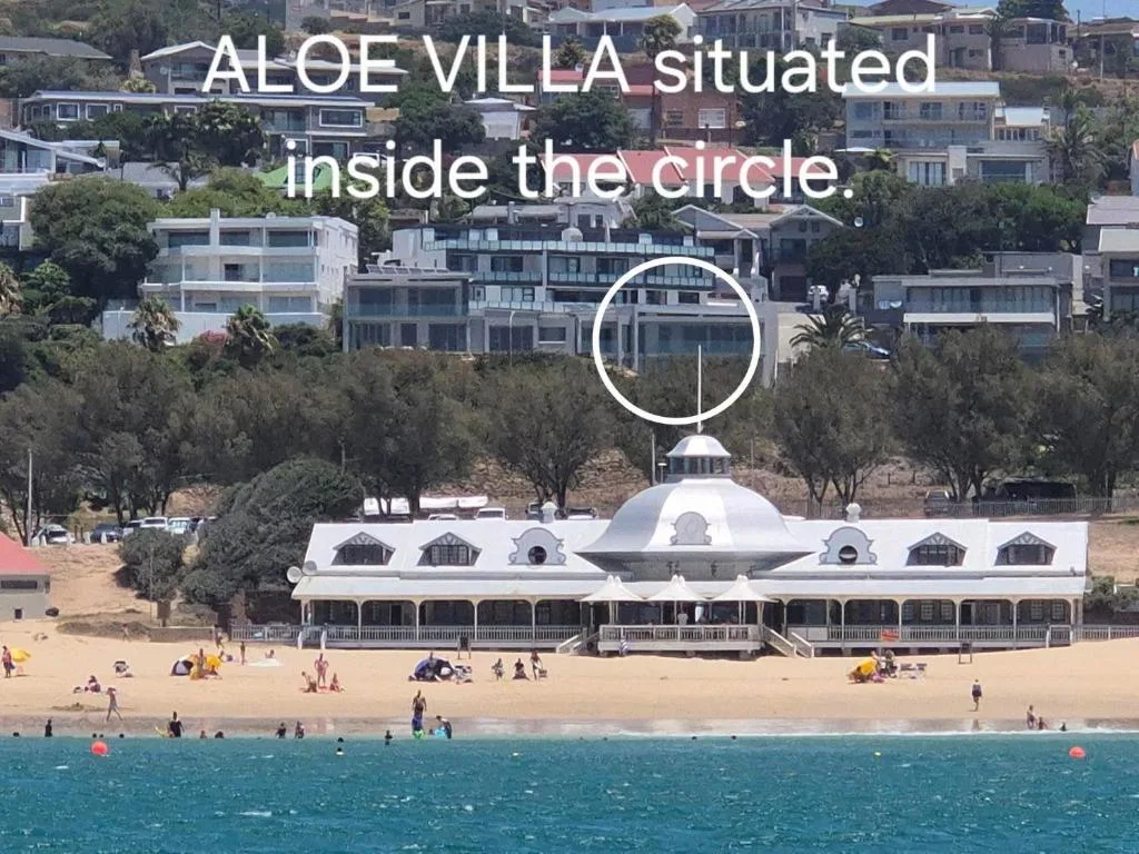 Beachfront villa with distinctive domed roof overlooking sandy beach and ocean