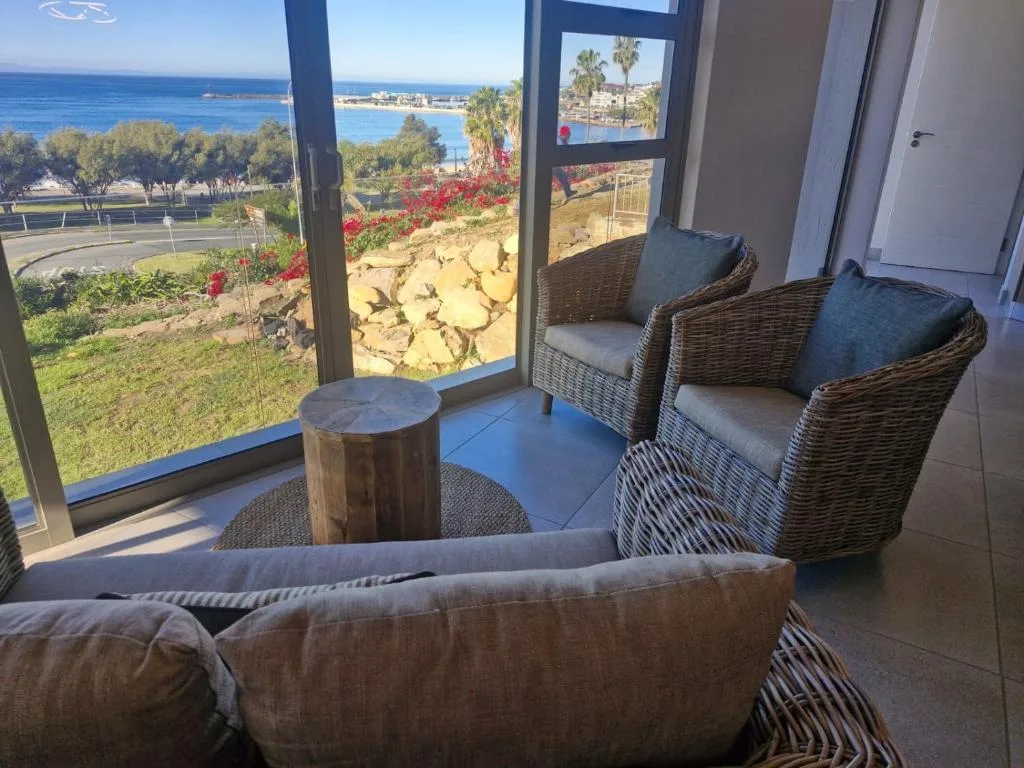 Coastal ocean view with palm trees and blue sea from lounge seating area