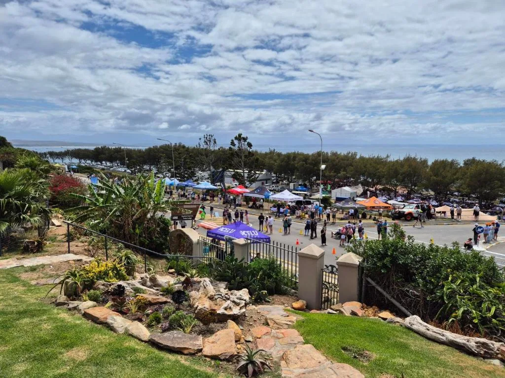 Scenic coastal town view with lagoon and beachfront market activity