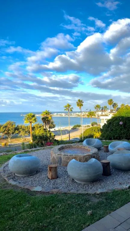 Coastal lagoon and town vista with palm trees under blue sky