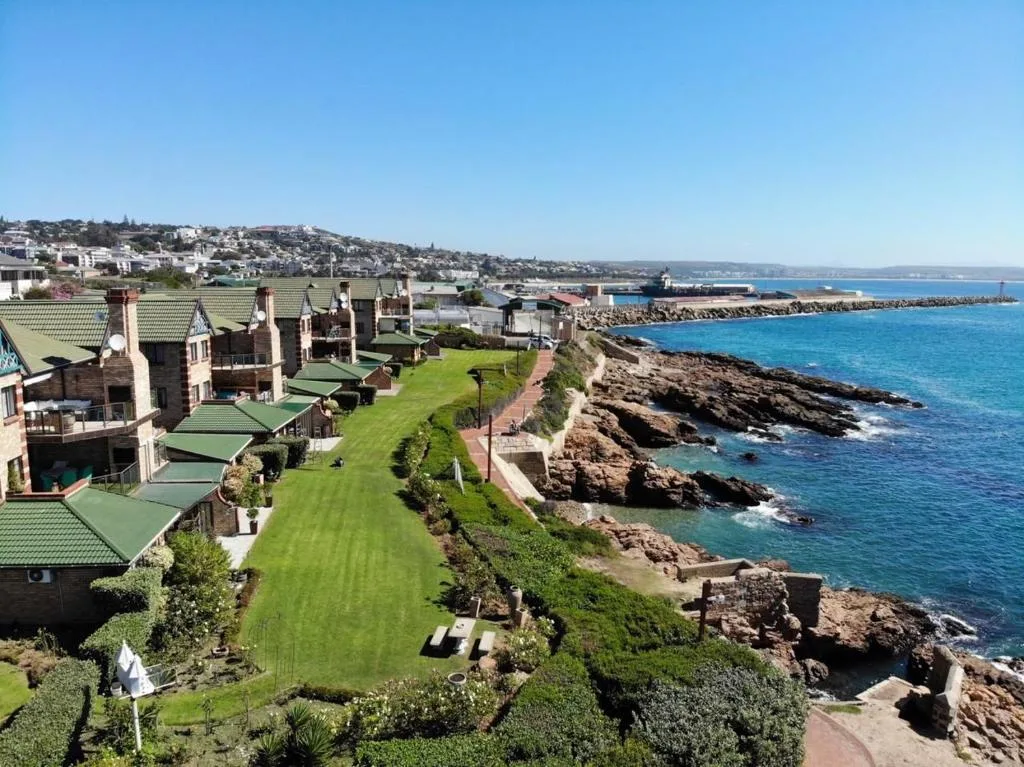 Coastal property overlooking rocky shores and turquoise ocean waters