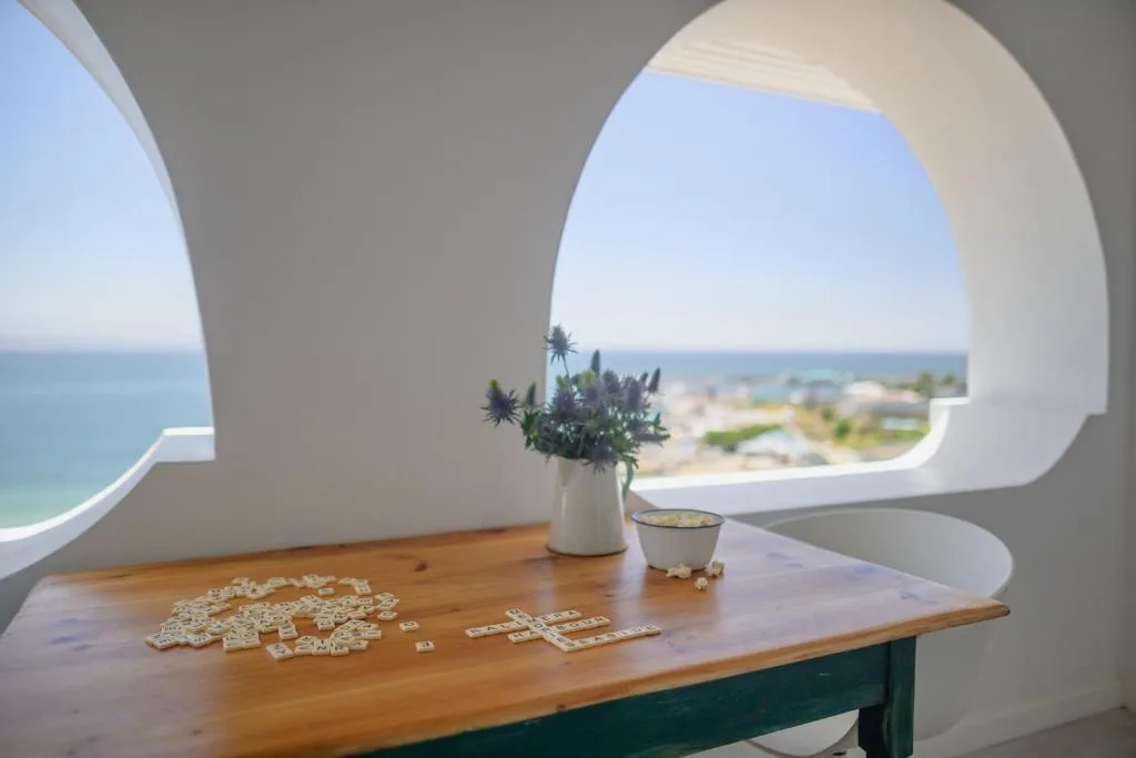 Ocean vista framed by modern white archway with coastal landscape beyond