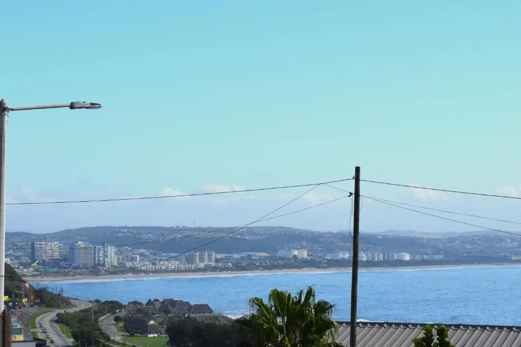 Sweeping coastal view of Mossel Bay beach and town with blue ocean horizon