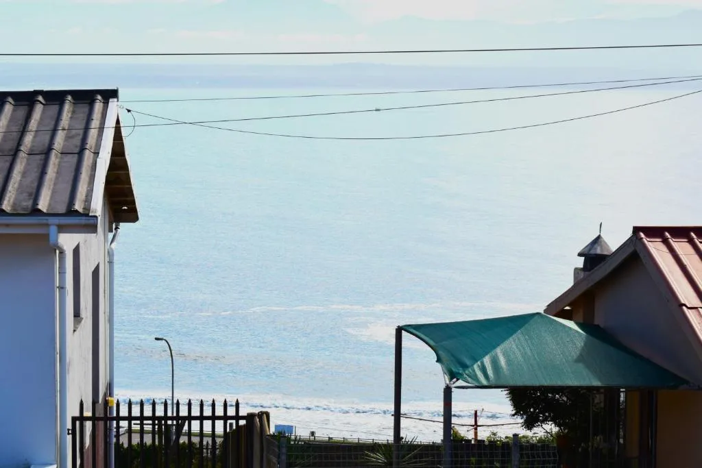 Ocean view from property with beach and coastal landscape visible