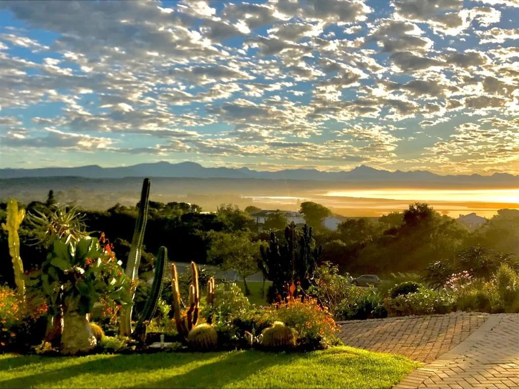 Panoramic lagoon and mountain vista at golden sunrise over Garden Route