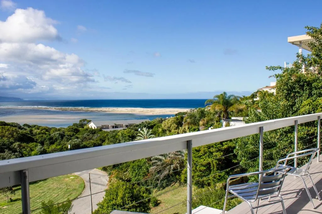 Expansive ocean and lagoon views from elevated deck with white railings