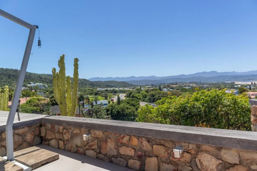 Mountain valley vista from elevated deck with lush vegetation below