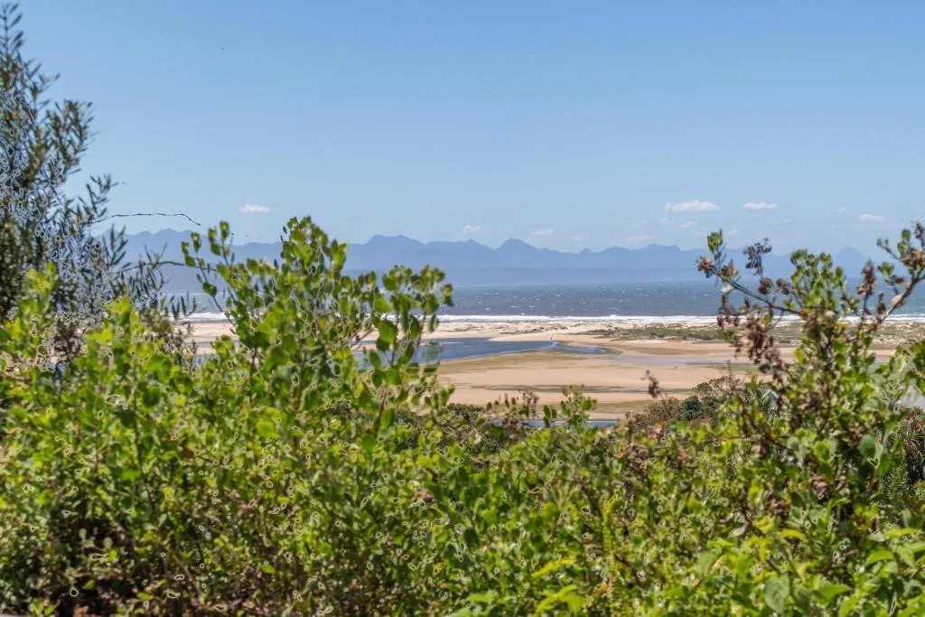 Sweeping vista of lagoon, beach, and distant mountains from property viewpoint