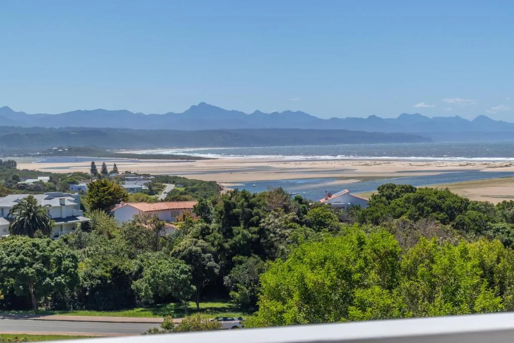 Panoramic vista of lagoon, valley, and distant mountains from elevated vantage point