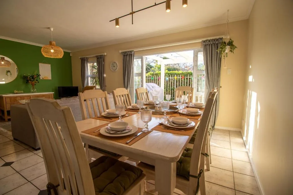 Elegant dining room with set table and garden view doors