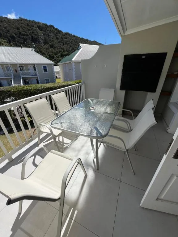Outdoor patio with dining table, chairs, and mountain views beyond