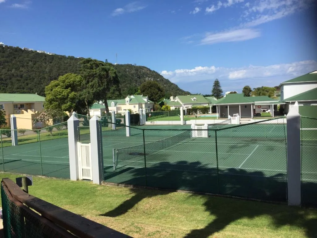 Tennis courts with manicured lawns and mountain views at the resort facility