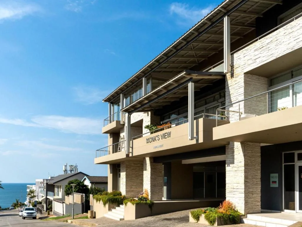 Modern multi-story brick building with ocean views and covered deck areas