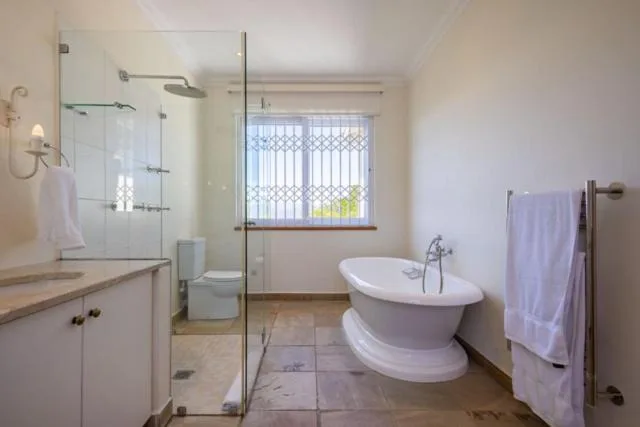 Spacious bathroom with freestanding bathtub, walk-in shower, and vanity