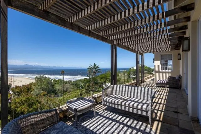 Shaded pergola deck with ocean and beach views over Plettenberg Bay