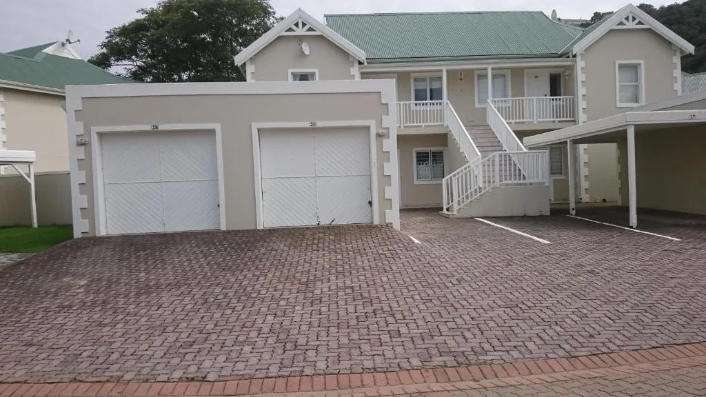 Modern villa with double garage and paved driveway entrance