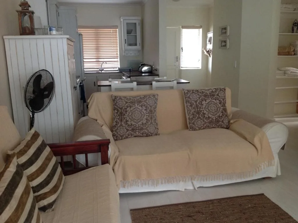 Cream sofa with patterned cushions in open-plan living space