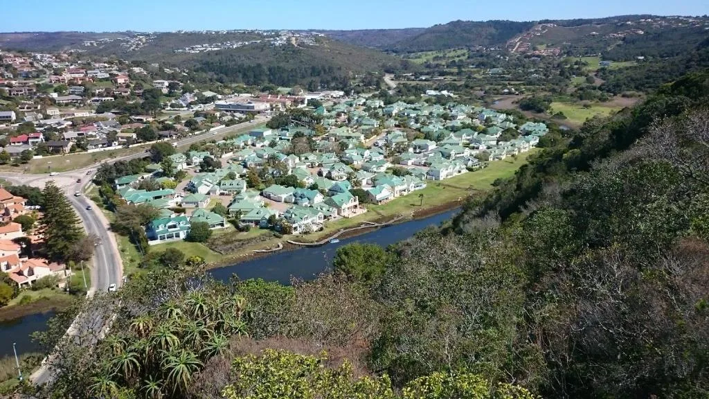 Aerial view of Riverclub estate with turquoise roofs and river valley below