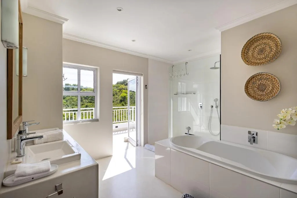 Spacious modern bathroom with dual vanities, freestanding tub, and walk-in shower
