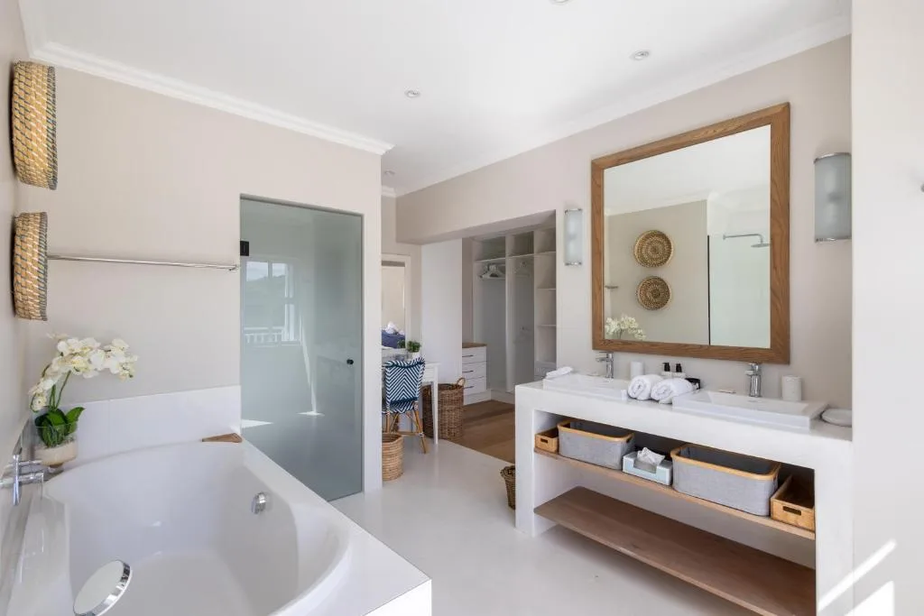 Spacious modern bathroom with freestanding tub, vanity, and glass shower enclosure