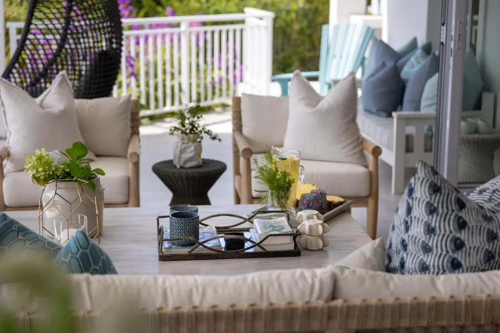 Elegant outdoor seating area with cushioned chairs and ocean views beyond