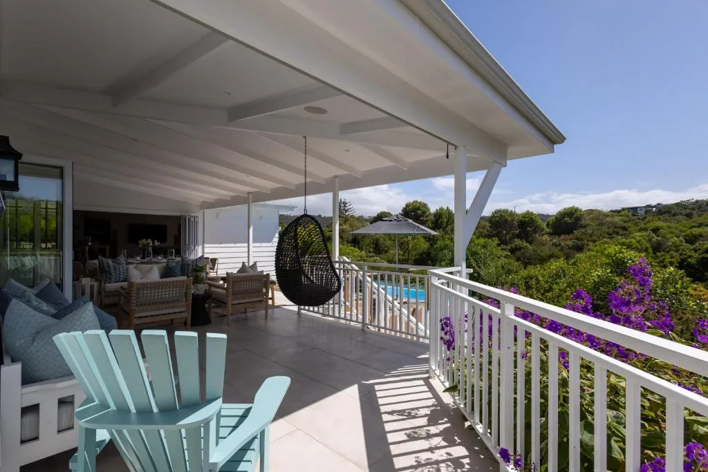 Spacious covered deck with lounge seating and mountain views