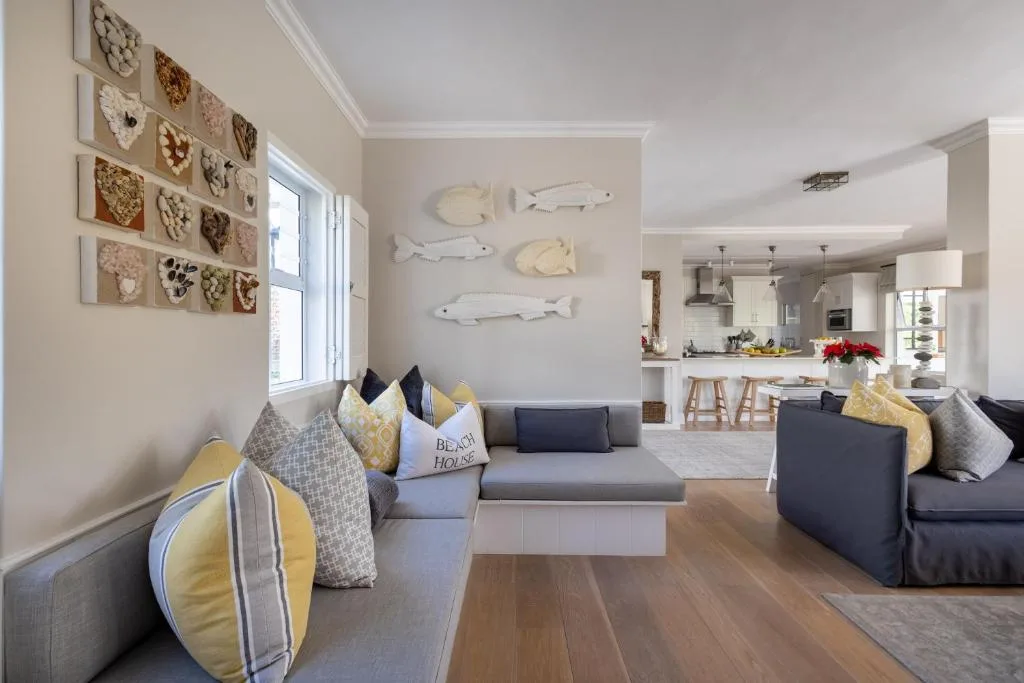 Spacious open-plan lounge with comfortable seating and coastal decor