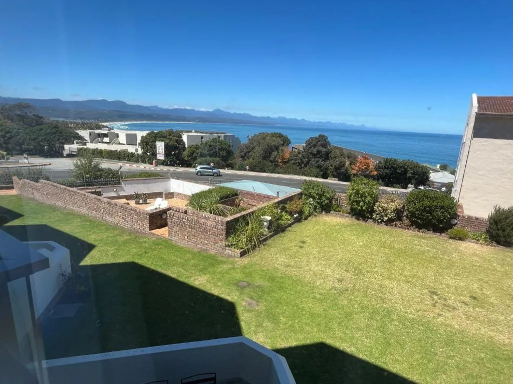 Scenic coastal view of Plettenberg Bay with mountains and ocean from property