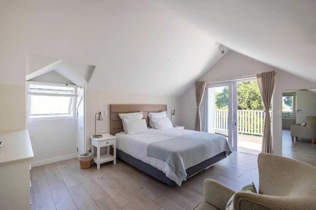 Spacious bedroom with double bed, deck access, and natural light