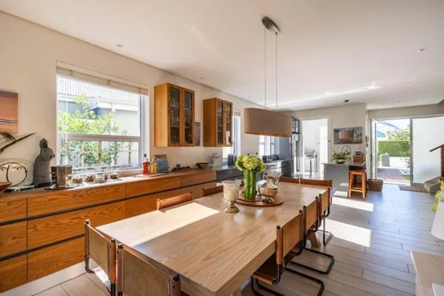Open-plan kitchen with wooden cabinetry, island counter, and dining area