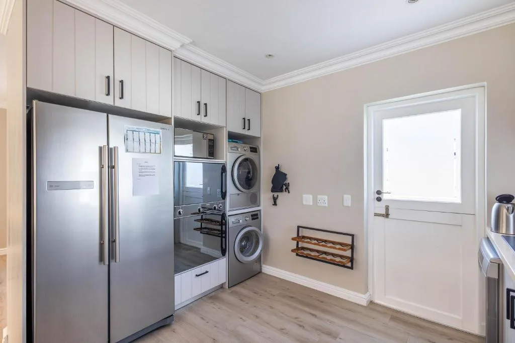 Modern kitchen with stainless steel appliances and white cabinetry