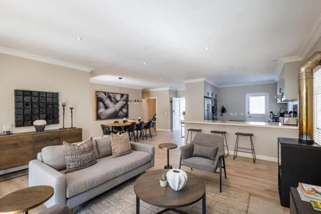 Open-plan living area with gray sofa, wooden coffee table, and modern furnishings