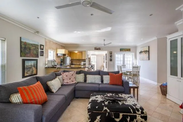 Open-plan lounge with gray sectional sofa and colorful accent pillows