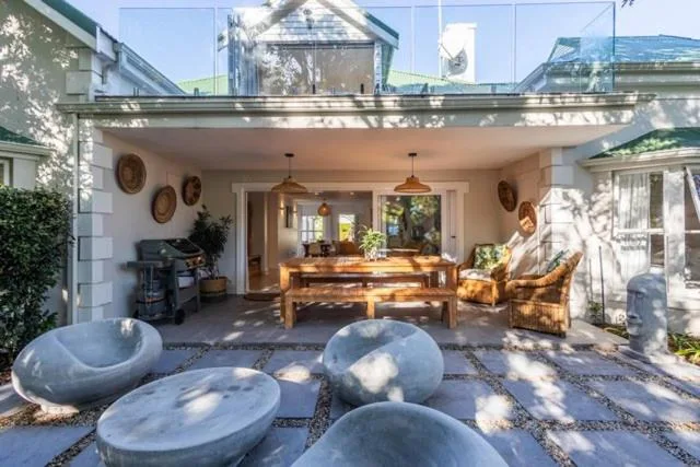 Covered patio with seating area and stone bowl features overlooking interior spaces