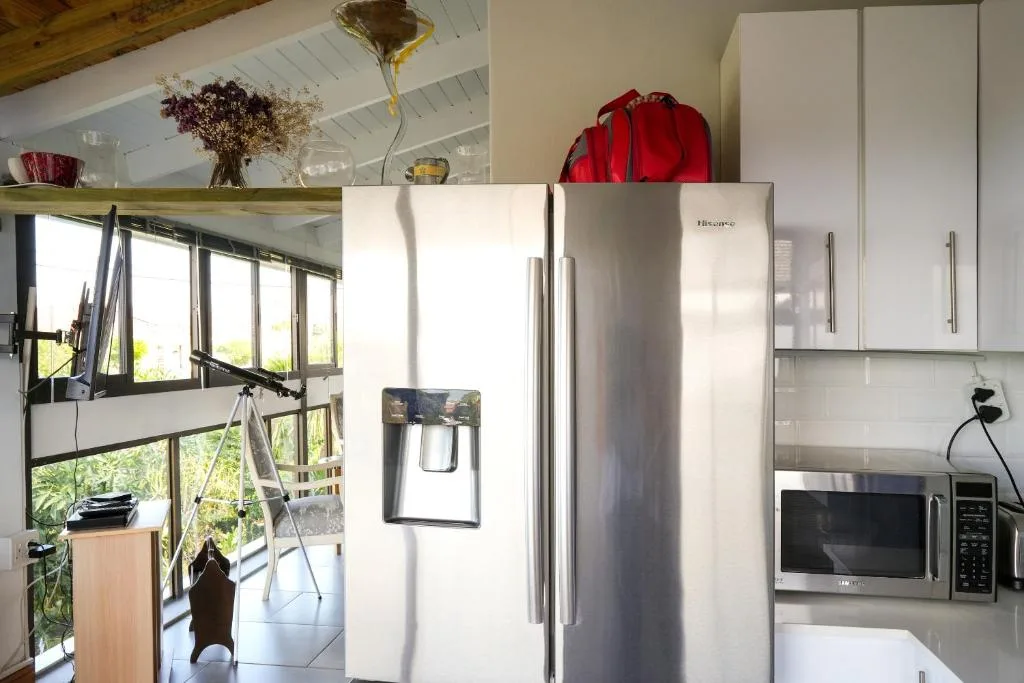 Modern kitchen with stainless steel refrigerator and microwave appliances