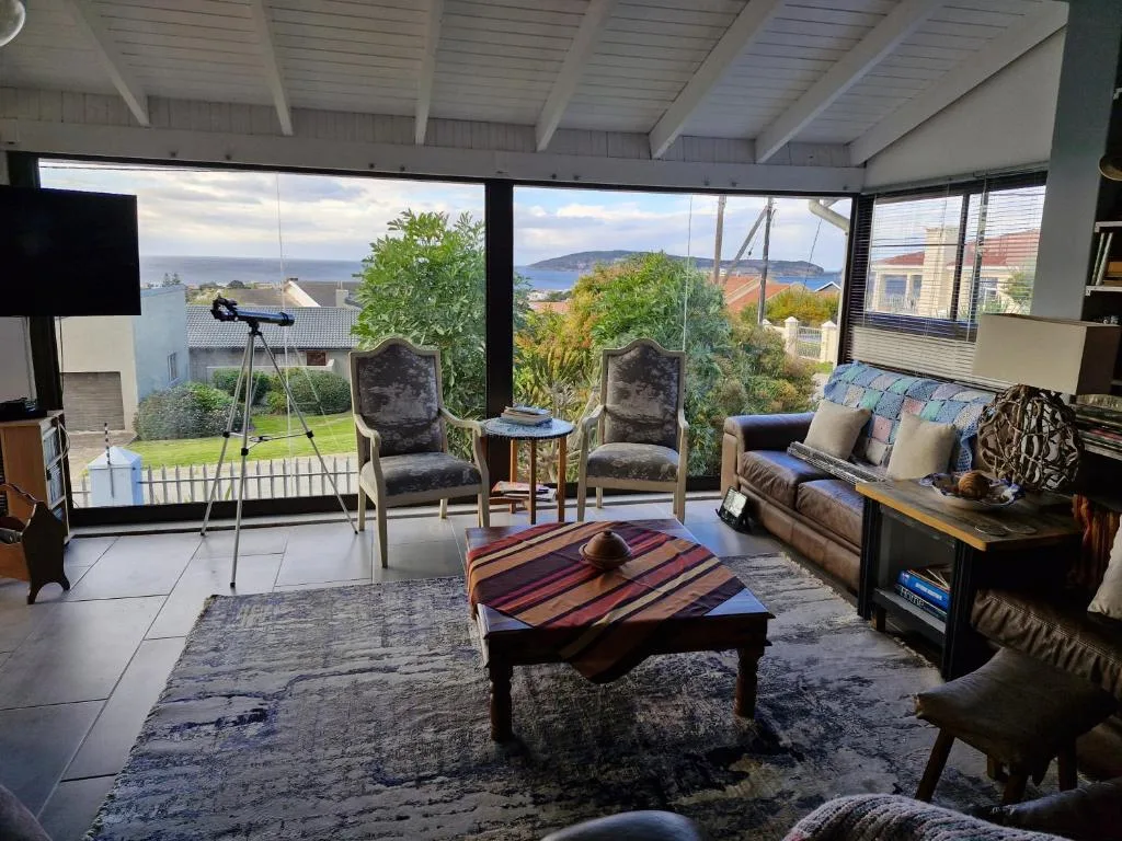 Spacious living room with ocean views through large windows and contemporary furnishings