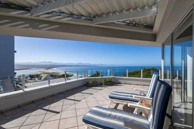 Spacious terrace with loungers overlooking Plettenberg Bay and mountains