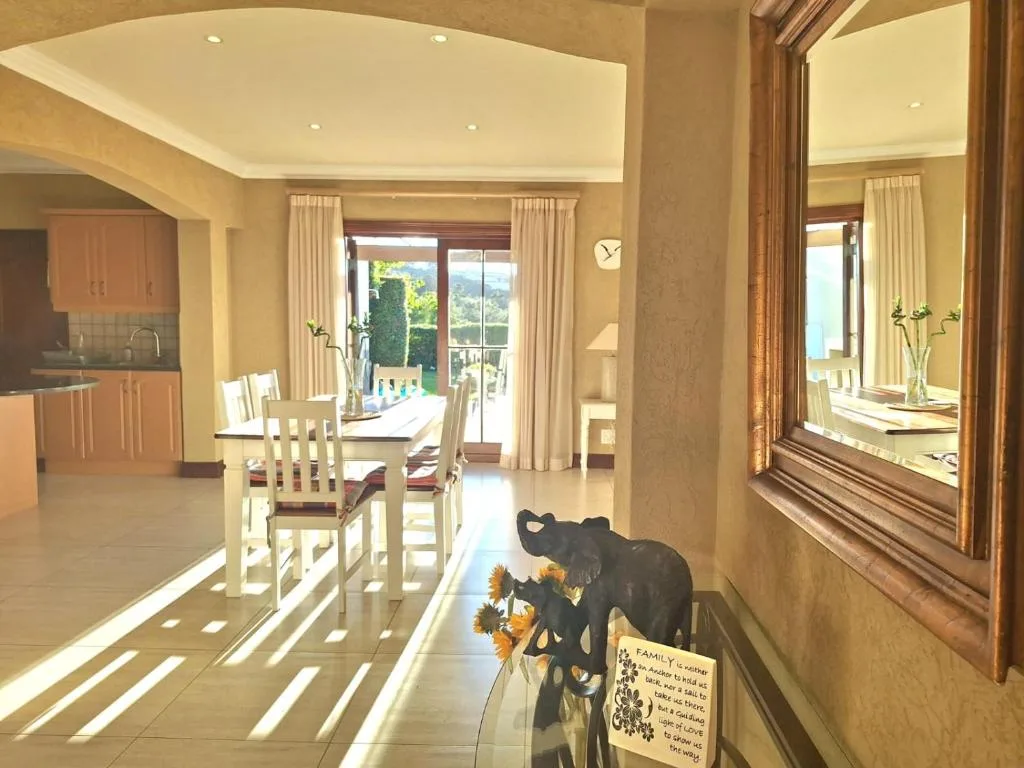 Bright open-plan lounge and dining area with garden views through glass doors